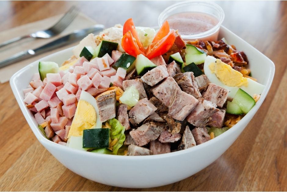 picture of a bowl with chicken, steak, salad, ham, boiled egg